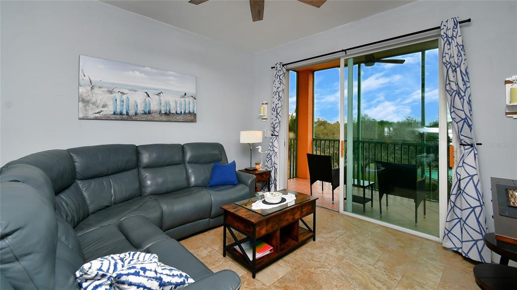 2090 Matecumbe Key Road, Unit 1308 Punta Gorda, FL 33955 - Photo 14 of 29 a living room with furniture and a floor to ceiling window
