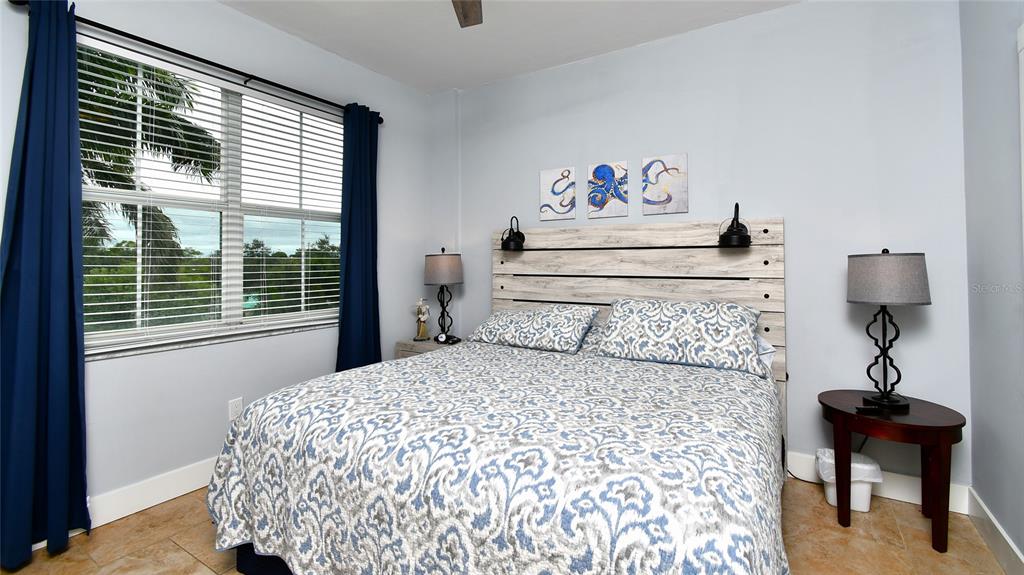 2090 Matecumbe Key Road, Unit 1308 Punta Gorda, FL 33955 - Photo 16 of 29 a bedroom with a bed and a chandelier