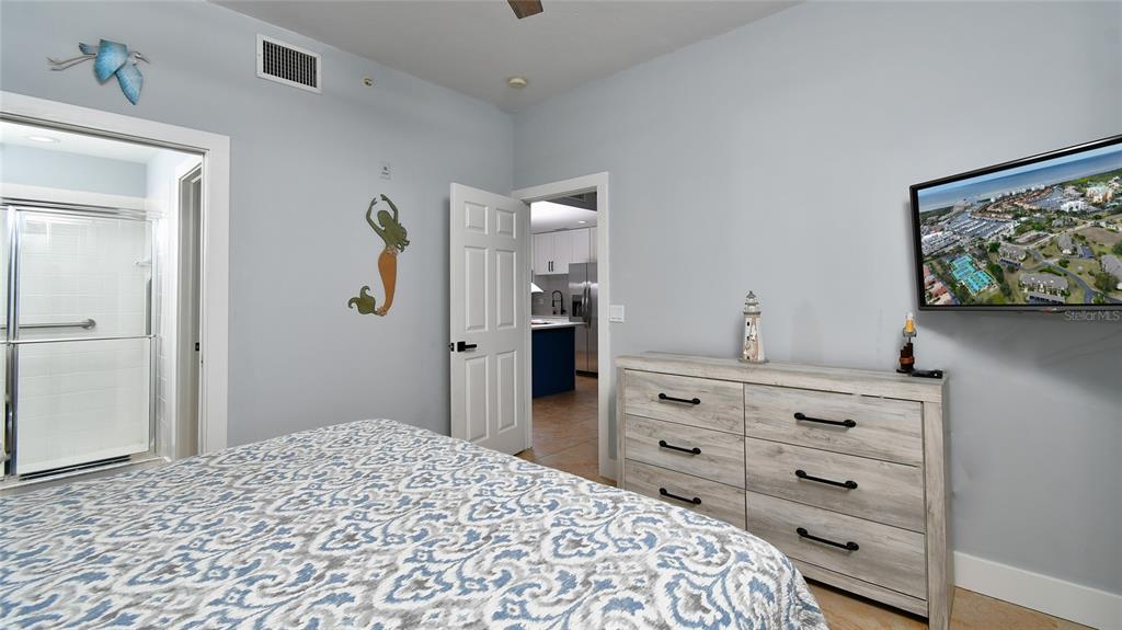 2090 Matecumbe Key Road, Unit 1308 Punta Gorda, FL 33955 - Photo 17 of 29 a bedroom with a bed and a dresser in it