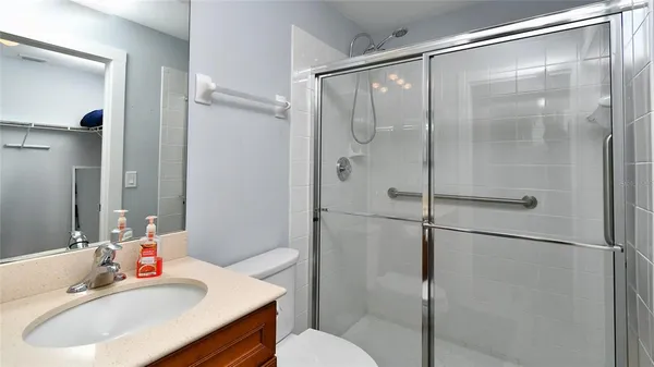a bathroom with a sink toilet and shower