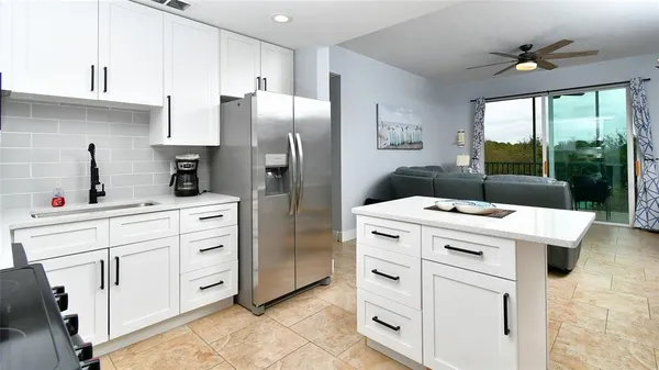 a kitchen with white cabinets and white appliances