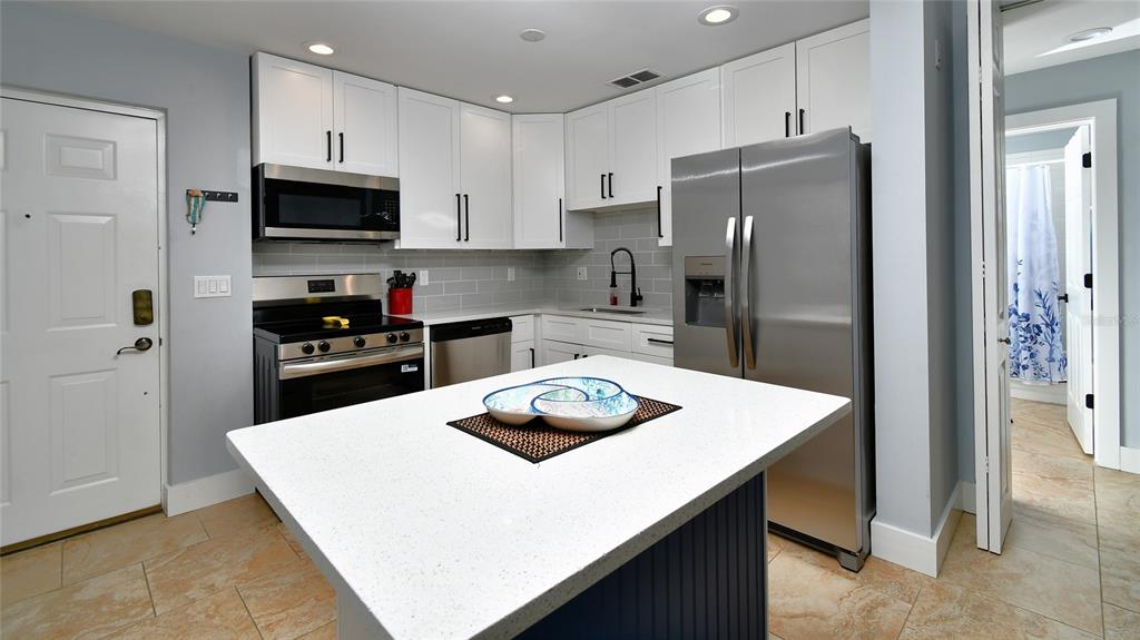 2090 Matecumbe Key Road, Unit 1308 Punta Gorda, FL 33955 - Photo 7 of 29 a kitchen with a sink a stove and refrigerator