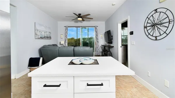 a kitchen with a table chairs and a refrigerator