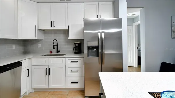 a kitchen with cabinets and a refrigerator