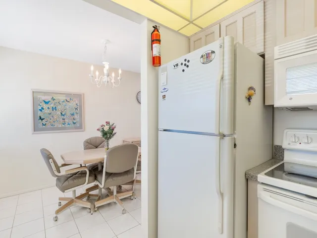 a white refrigerator freezer sitting in a kitchen