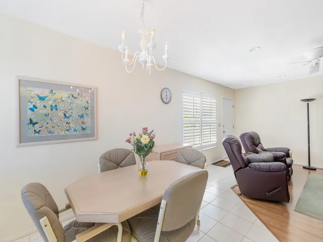 a view of a dining room with furniture and a chandelier