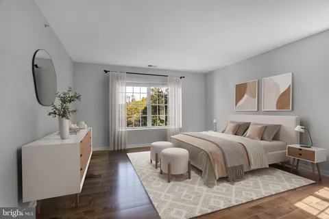 a bed room with a bed a couch and a window