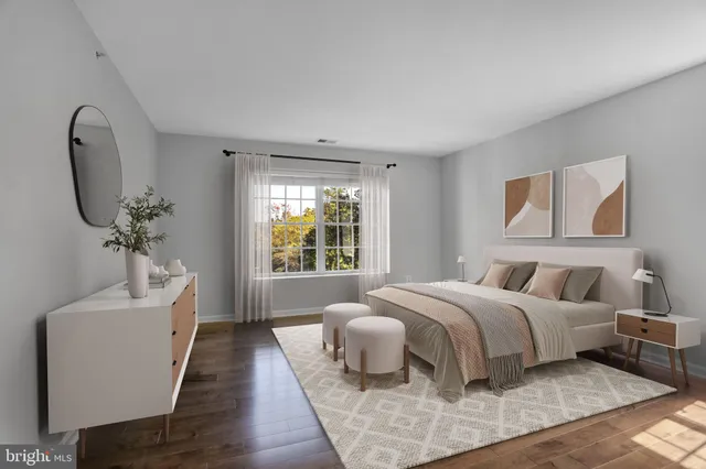 a bed room with a bed a couch and a window