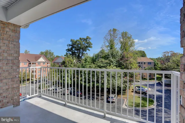 a view of a balcony with a floor to ceiling window and wooden fence