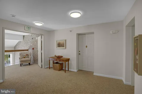 a view of work space with furniture and windows
