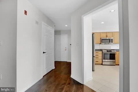 a view of a kitchen with a sink and a refrigerator