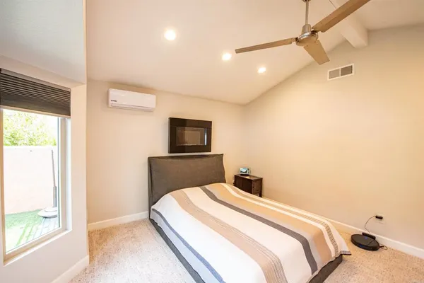 a bedroom with a bed and a tv