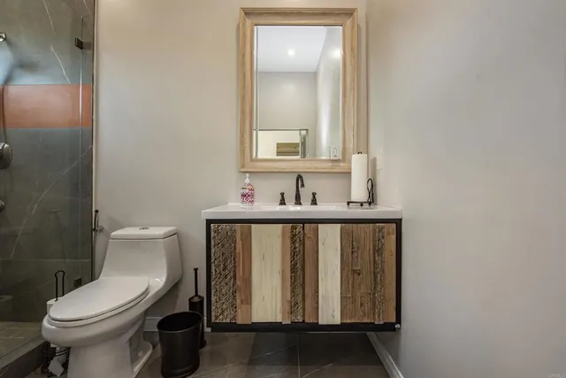 a bathroom with a toilet sink and mirror