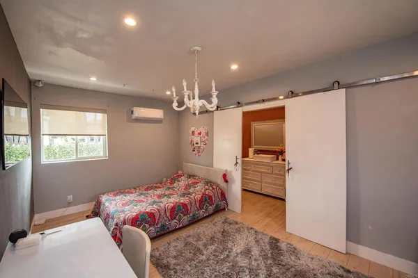 a bedroom with a bed and a window