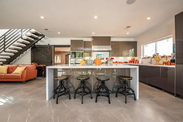a outdoor dining area with a table and chairs