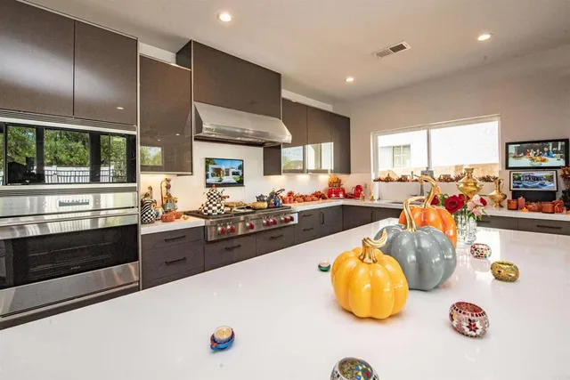 a kitchen with stainless steel appliances a stove a sink and a refrigerator