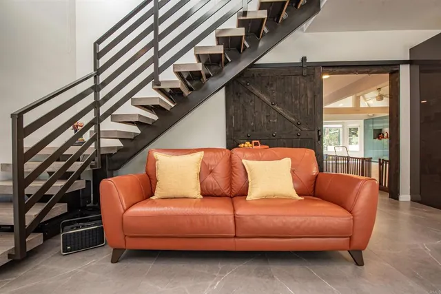a living room with furniture and a potted plant