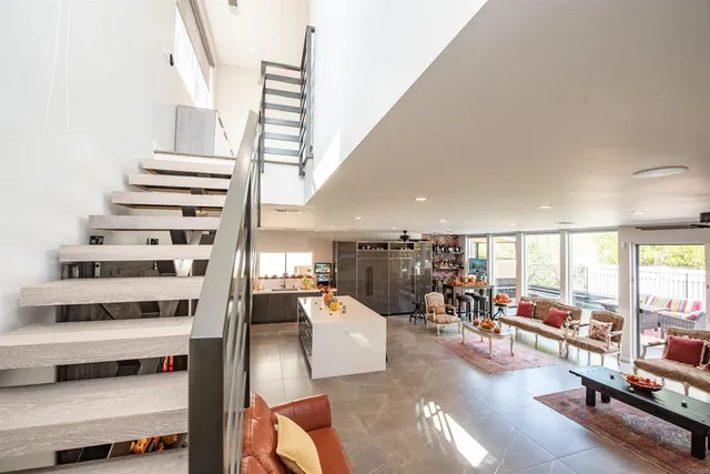 a view of a living room and workspace with furniture