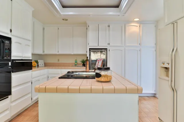 a bedroom with a bed a mirror and a large window