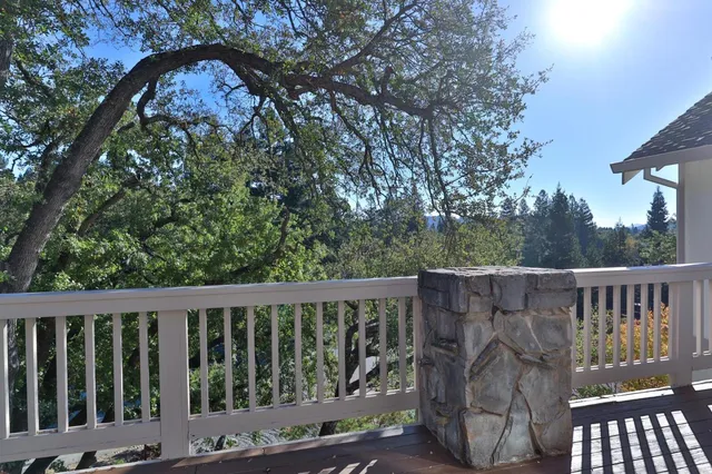 a view of a house with a tree in front of it