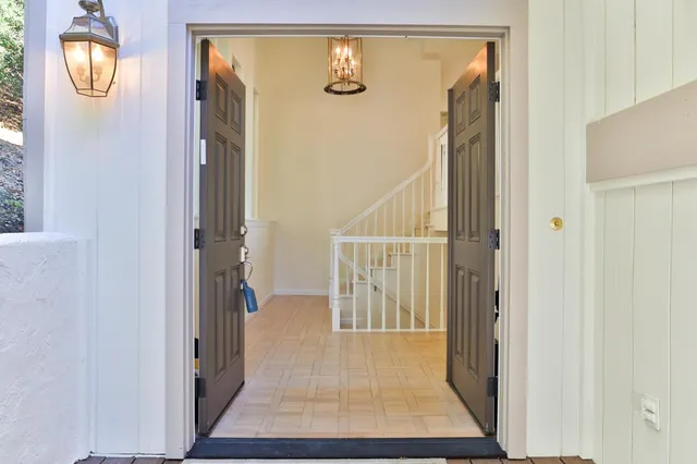a view of a dining room with furniture wooden floor and chandelier