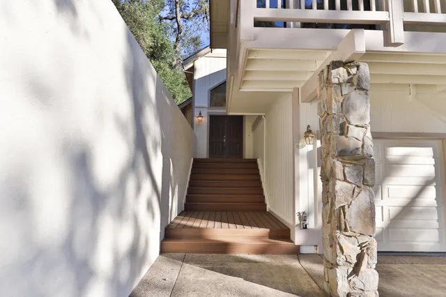 a view of staircase with white walls and a window