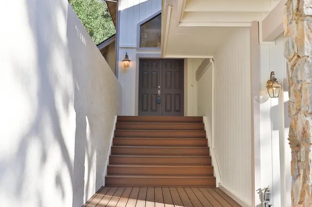 a view of staircase with railing and white walls