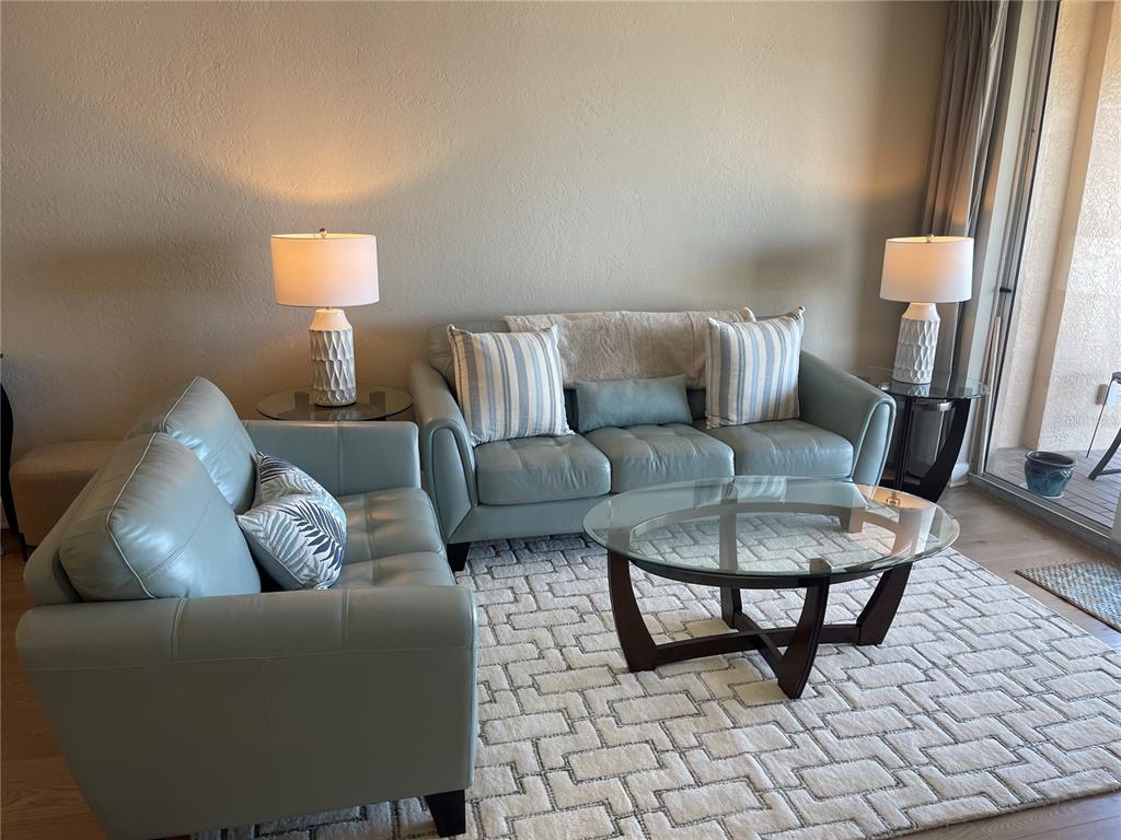 4651 South Atlantic Avenue, Unit 9105 Ponce Inlet, FL 32127 - Photo 13 of 20 a living room with furniture and a lamp