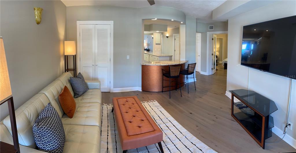 4651 South Atlantic Avenue, Unit 9105 Ponce Inlet, FL 32127 - Photo 16 of 20 a living room with furniture and a wooden floor