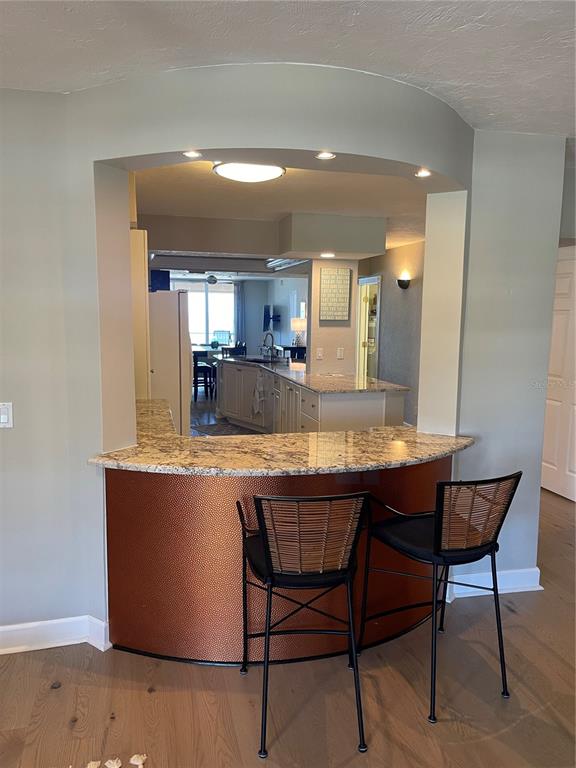 4651 South Atlantic Avenue, Unit 9105 Ponce Inlet, FL 32127 - Photo 17 of 20 a kitchen with a table and chairs in it