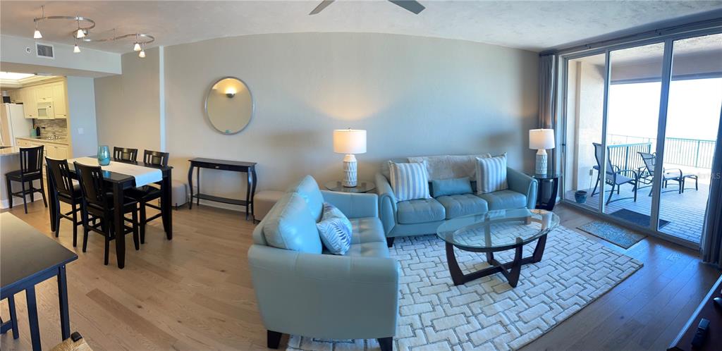 4651 South Atlantic Avenue, Unit 9105 Ponce Inlet, FL 32127 - Photo 7 of 20 a living room with furniture couches and a large window