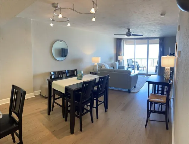 a dining room with furniture a livingroom and chandelier