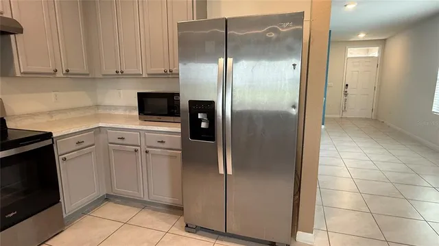 a open kitchen with kitchen island a sink stainless steel appliances and cabinets