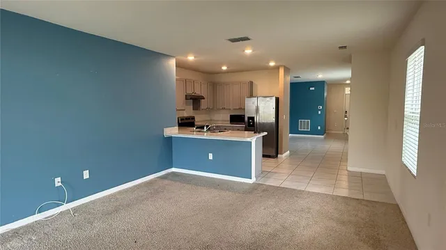 an empty room with closet and windows