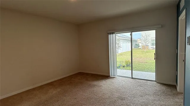 an empty room with closet and a bathroom