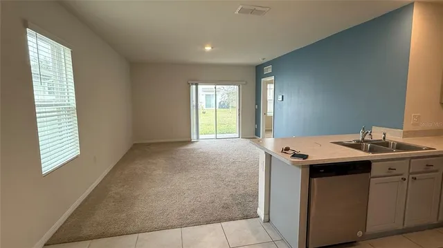 a kitchen with cabinets stainless steel appliances and a sink