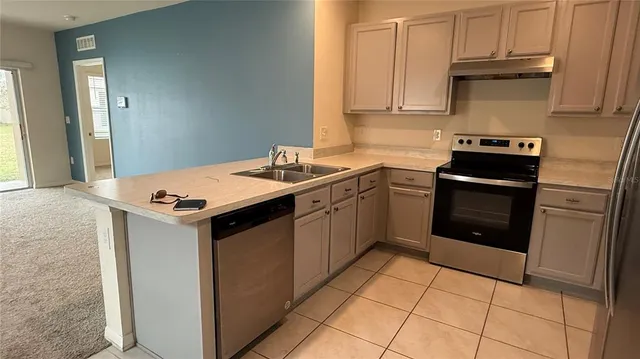 a kitchen with a refrigerator and a stove