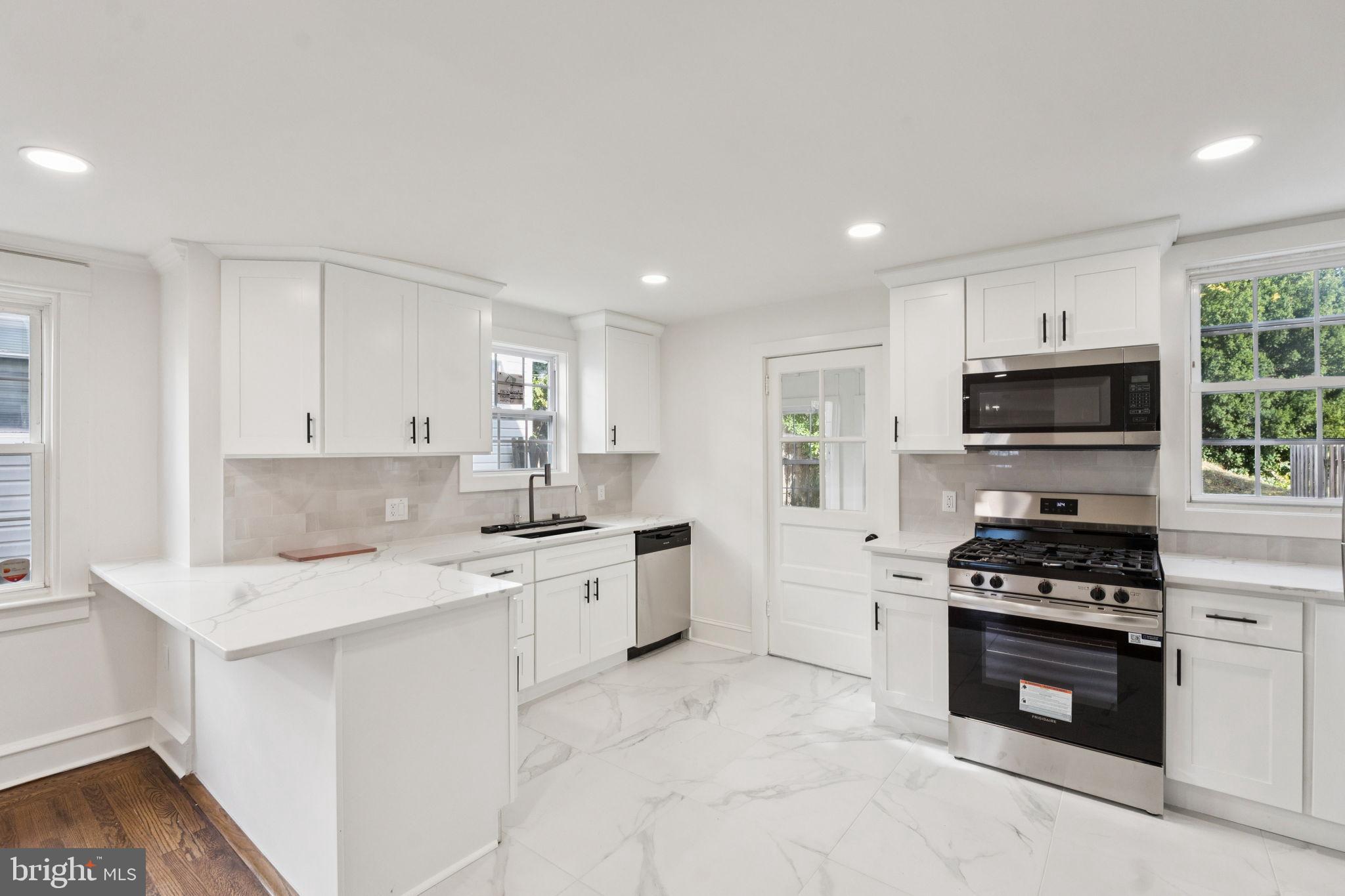 333 Blanchard Road Drexel Hill, PA 19026 - Photo 16 of 45 a kitchen with a sink stove top oven and cabinets