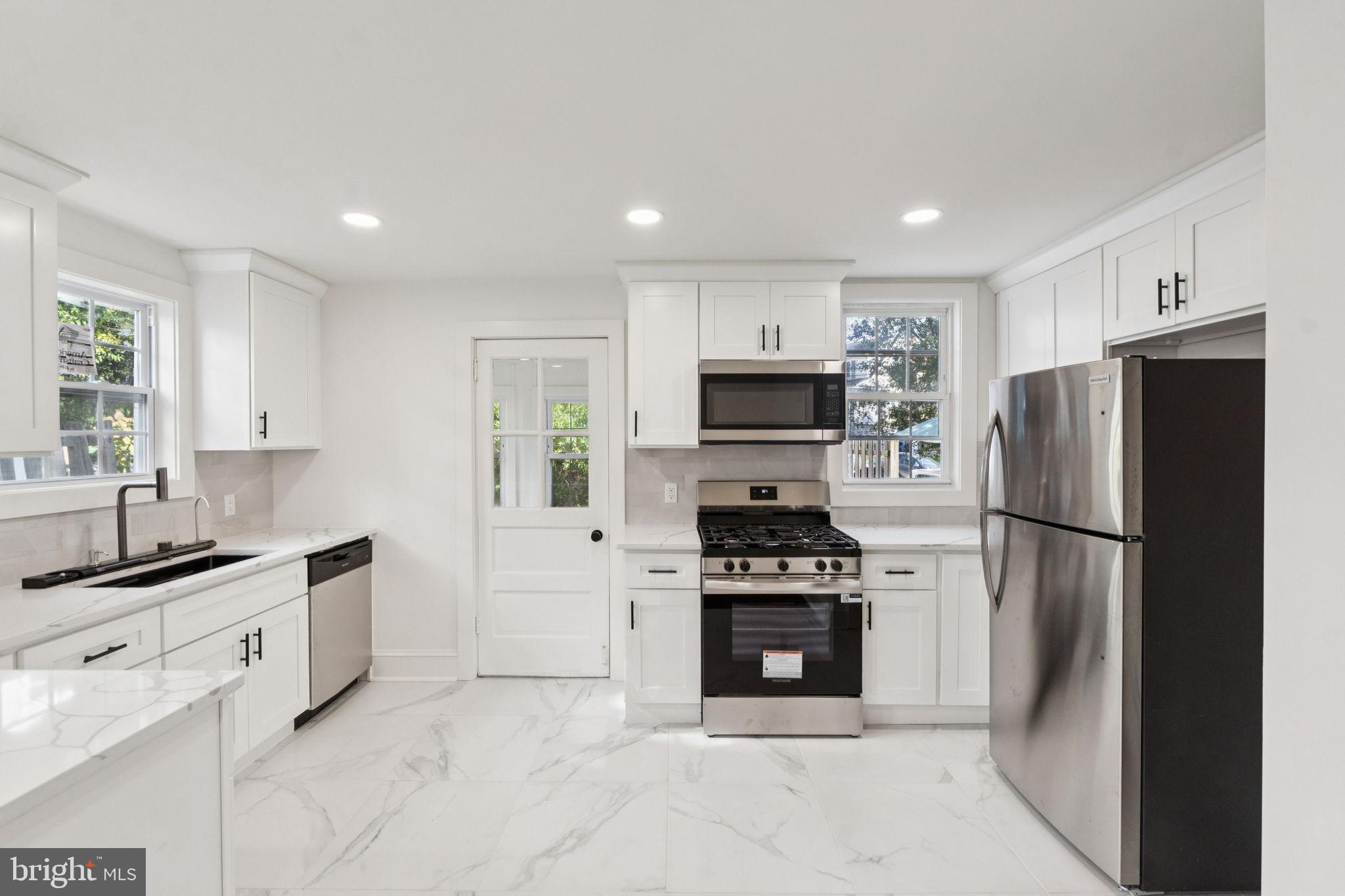 333 Blanchard Road Drexel Hill, PA 19026 - Photo 18 of 45 a kitchen with stainless steel appliances a refrigerator stove microwave and sink