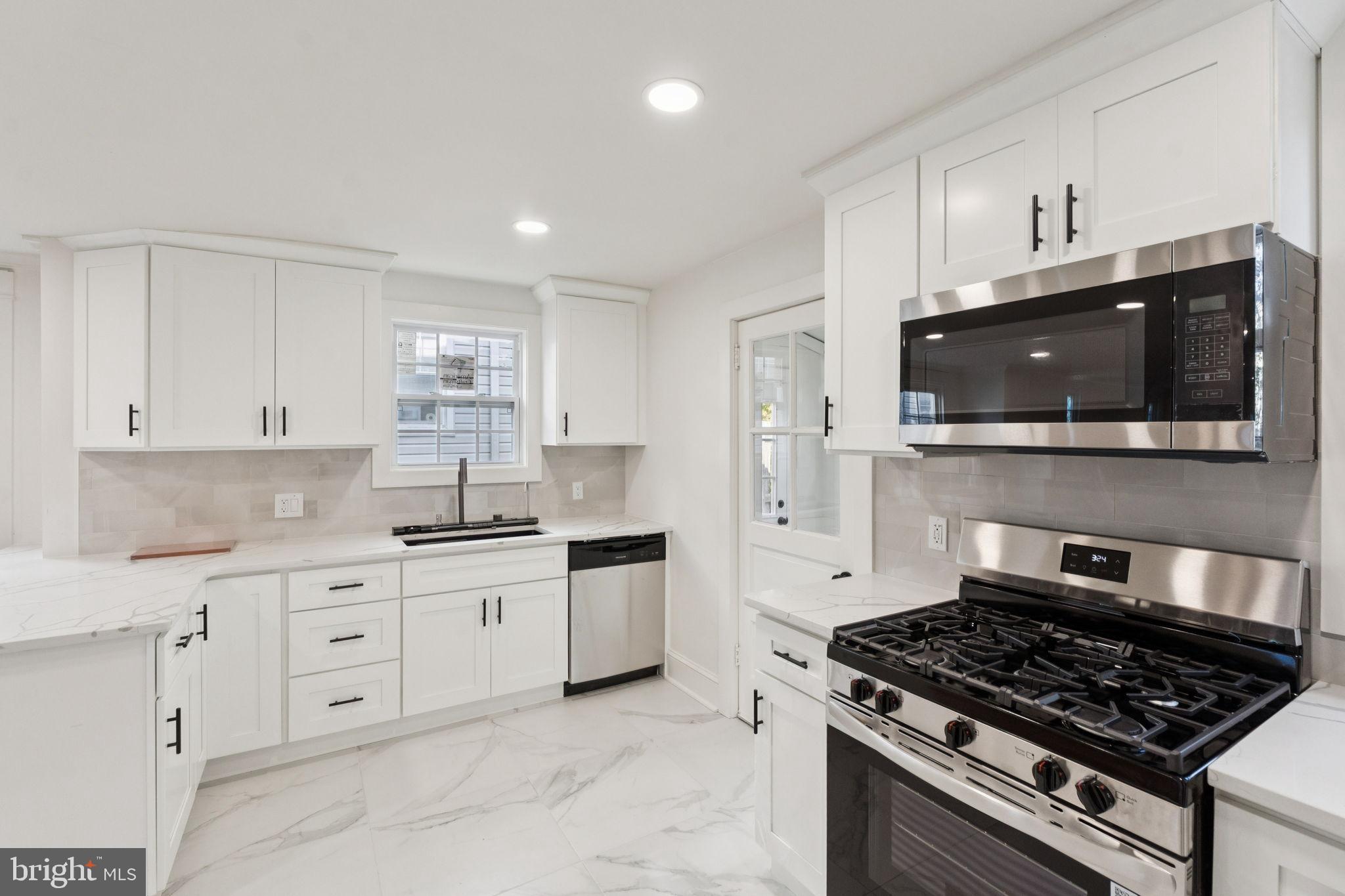 333 Blanchard Road Drexel Hill, PA 19026 - Photo 20 of 45 a kitchen with stainless steel appliances a sink a stove and microwave