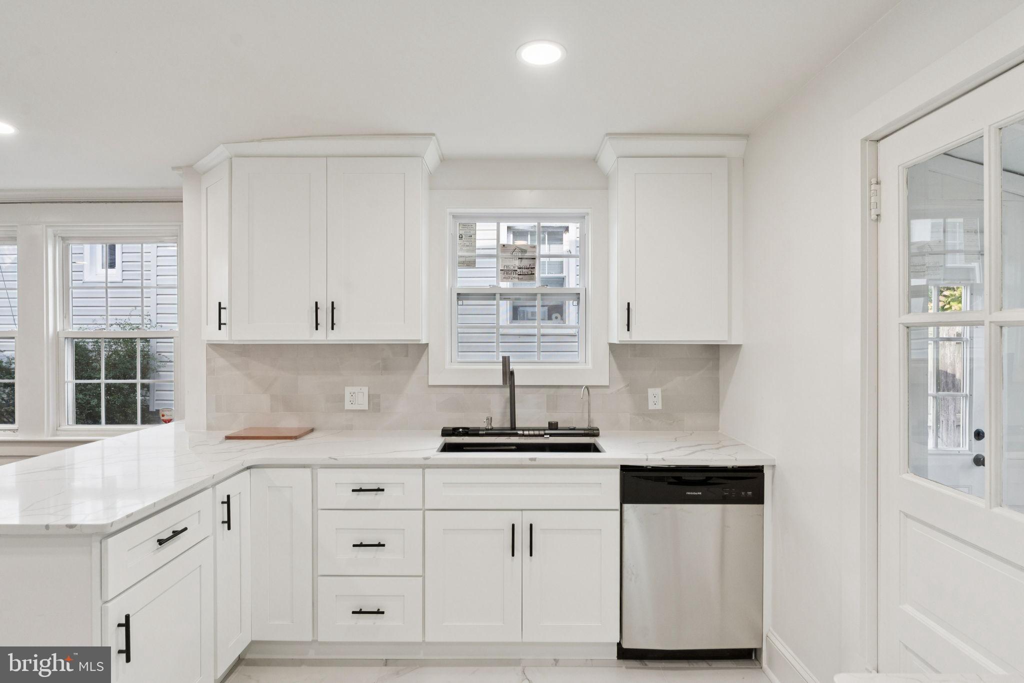 333 Blanchard Road Drexel Hill, PA 19026 - Photo 21 of 45 a kitchen with granite countertop white cabinets and white appliances