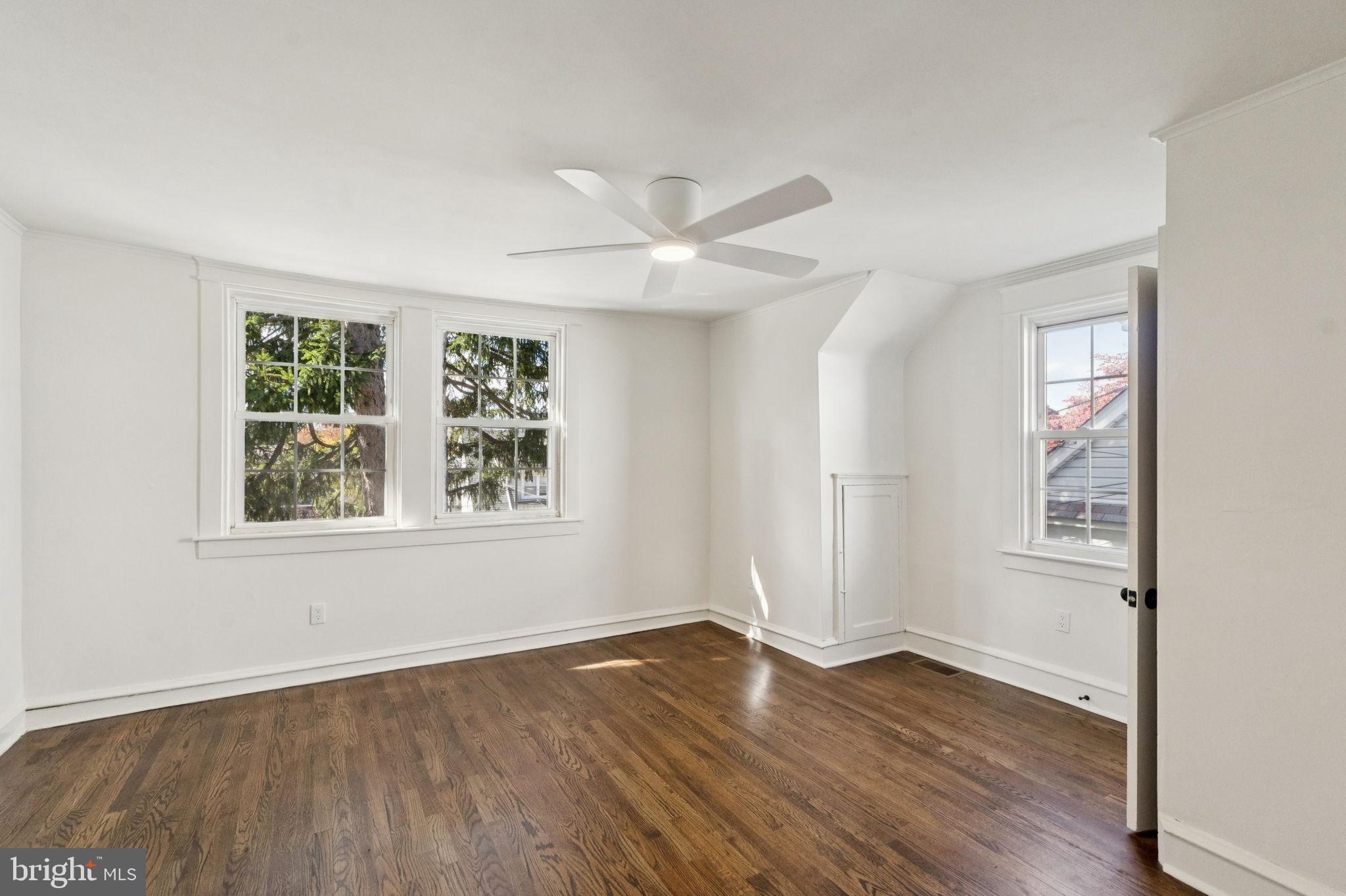 333 Blanchard Road Drexel Hill, PA 19026 - Photo 28 of 45 an empty room with wooden floor chandelier fan and windows