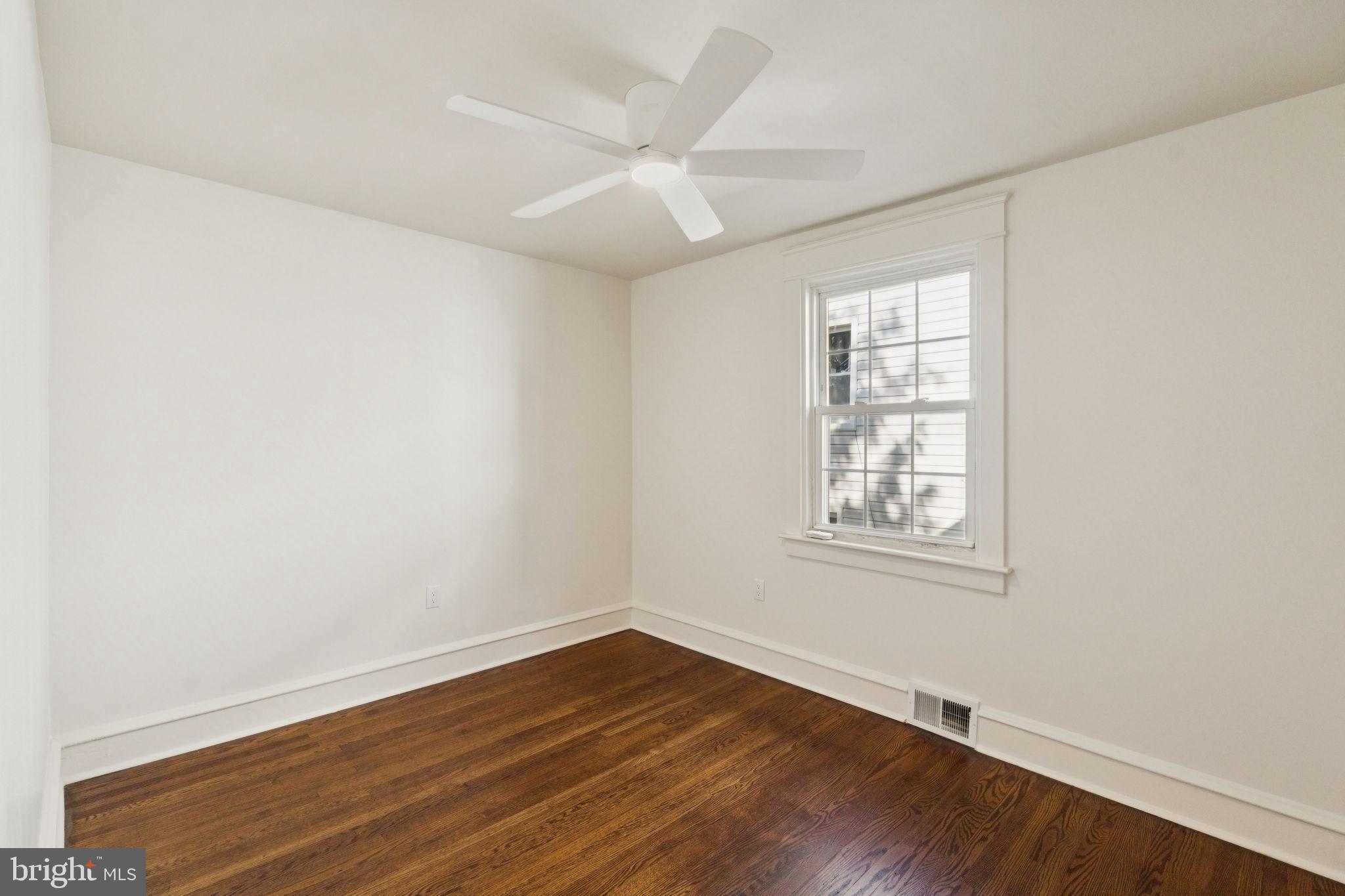 333 Blanchard Road Drexel Hill, PA 19026 - Photo 35 of 45 an empty room with wooden floor and windows