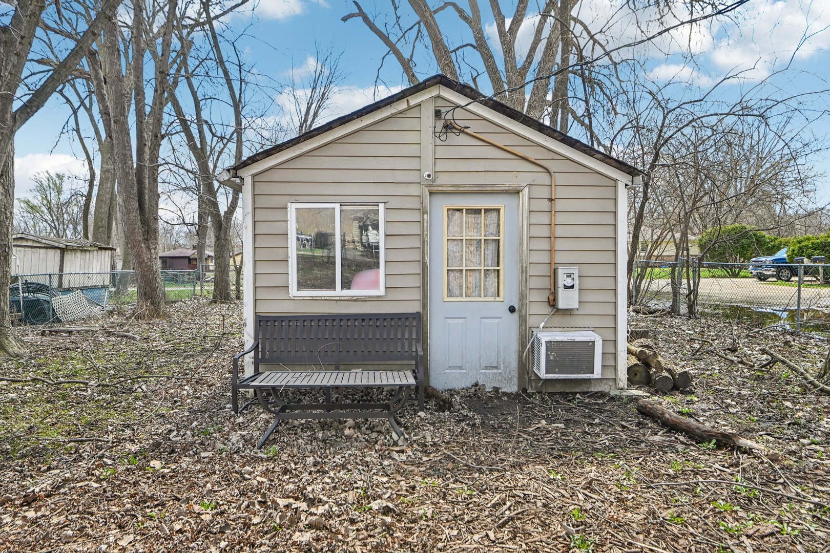 a view of a house with a yard and chairs