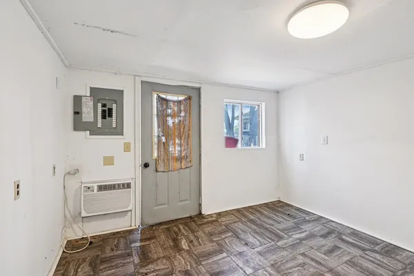 a view of a bedroom with wooden floor and bathroom