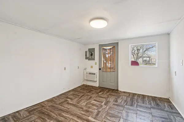 a view of a bedroom with wooden floor and cabinet