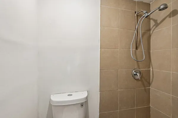 a bathroom with a toilet and a shower