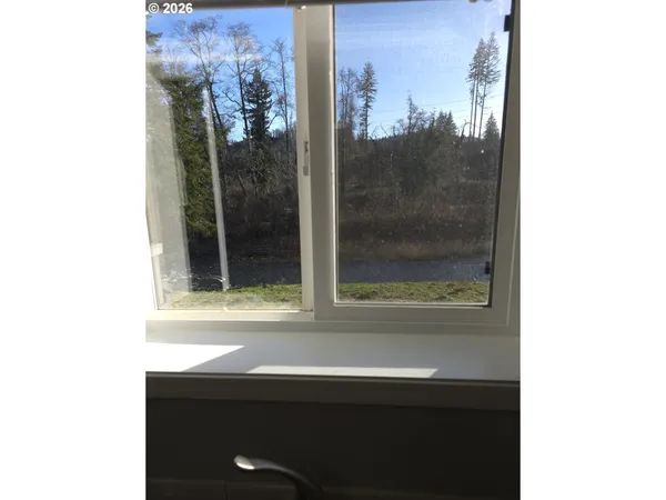 a kitchen with white cabinets and appliances