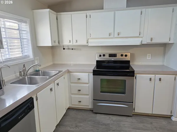 a view of an empty room and wooden floor