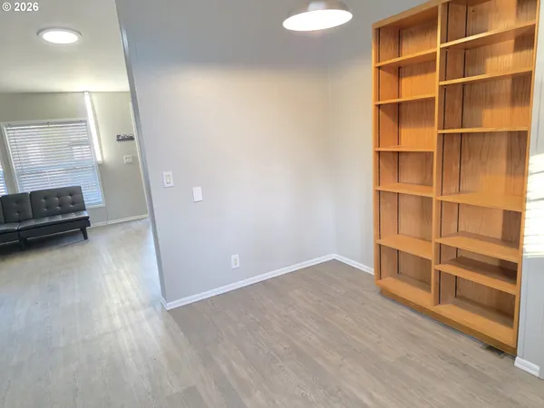a view of walk in closet with empty racks